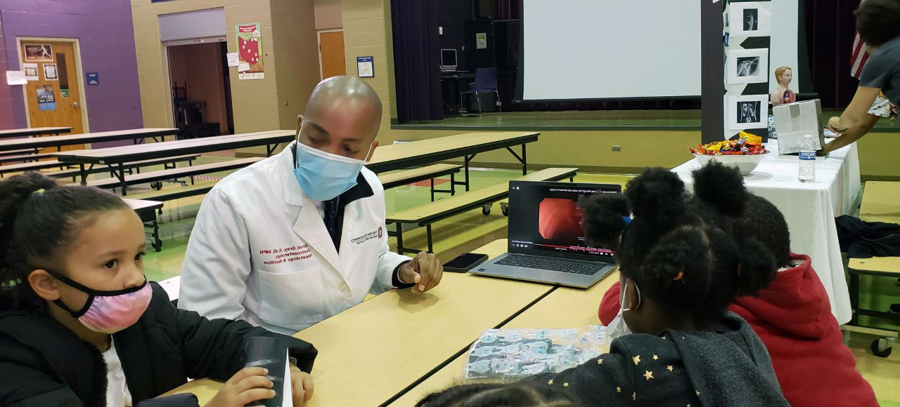 photo of healthcare professional with children at a table