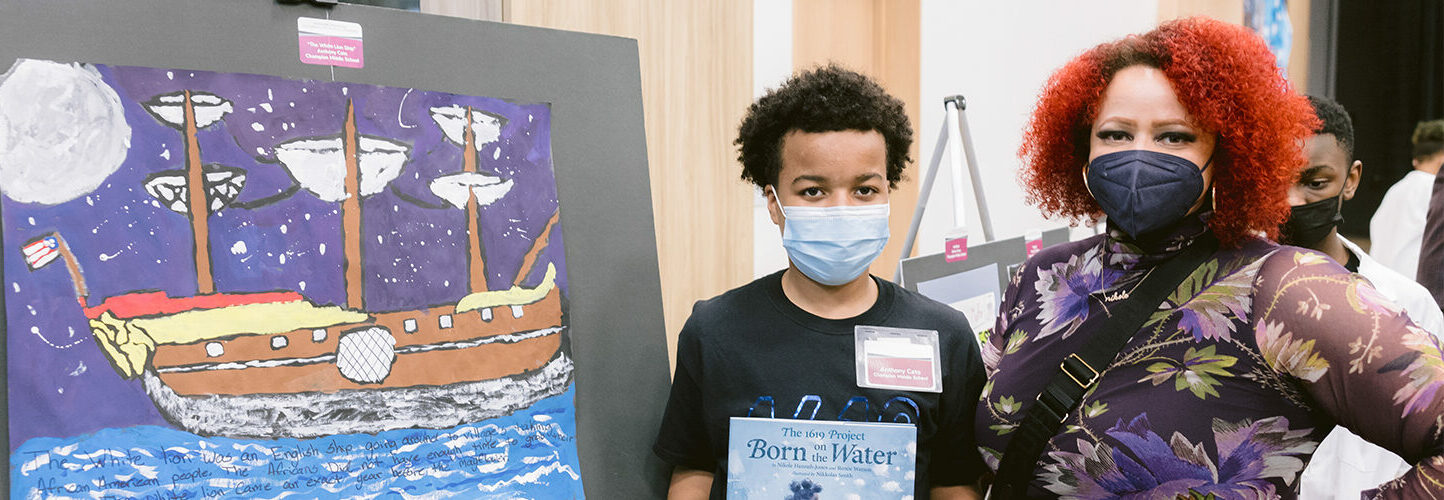 photo of Nikole Hannah-Jones with a student and his artwork