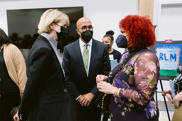 Photo of the president of the University Kristina M. Johnson, Dean Don Pope-Davis, and Nikole Hannah-Jones speaking to each other.