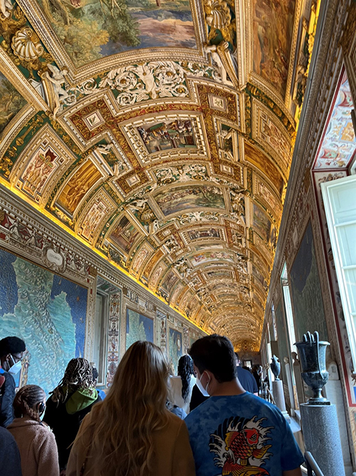 A photo of inside the Vatican Museum with a crowd around.
