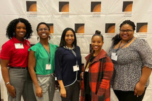 Group of people in front of a backdrop that says "Institute on Teaching and Mentoring"