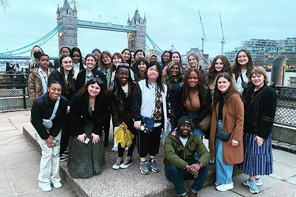 A group of students standing in front of a bridge in the UK.