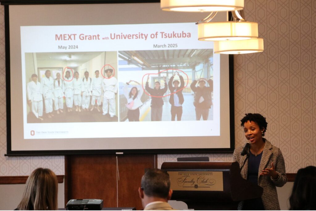 Carlotta Penn speaking at a podium for Global Hub reception